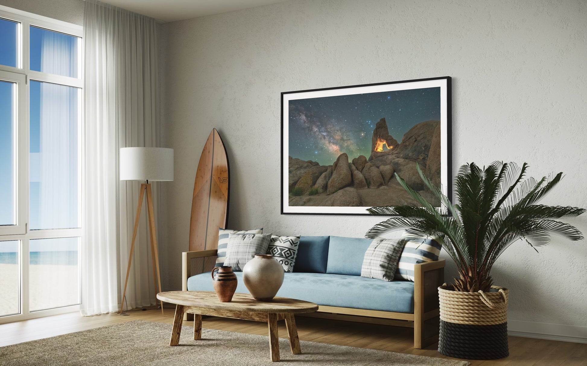 Stone and Stardust. A rock arch with milky way framed photo print hanging above the sofa in a living room.